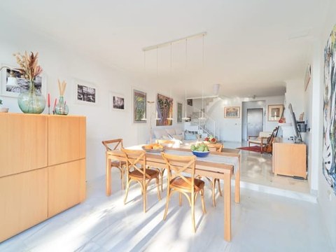 Comedor del chalet — segunda vista con mural y sillas Wishbone